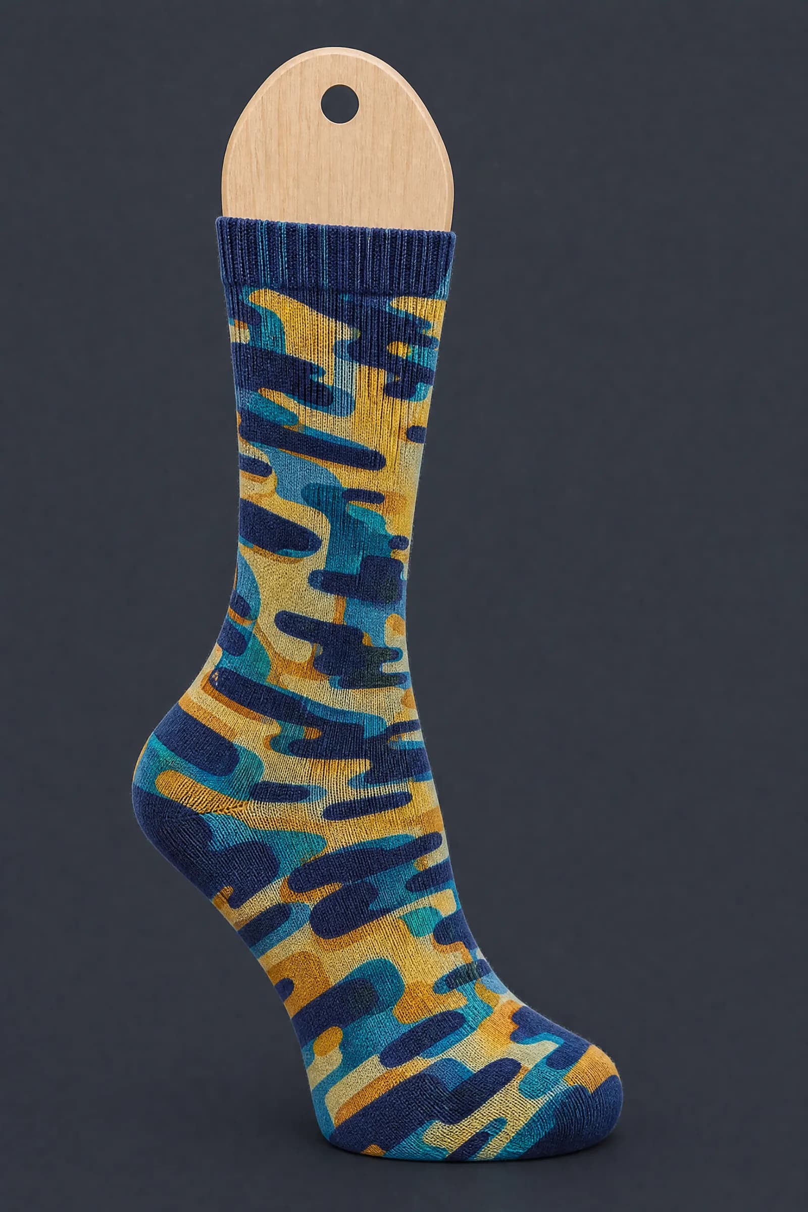 The Mark Overprint pattern on a sock stretched over a sock form, showing how the drawing curves and compresses