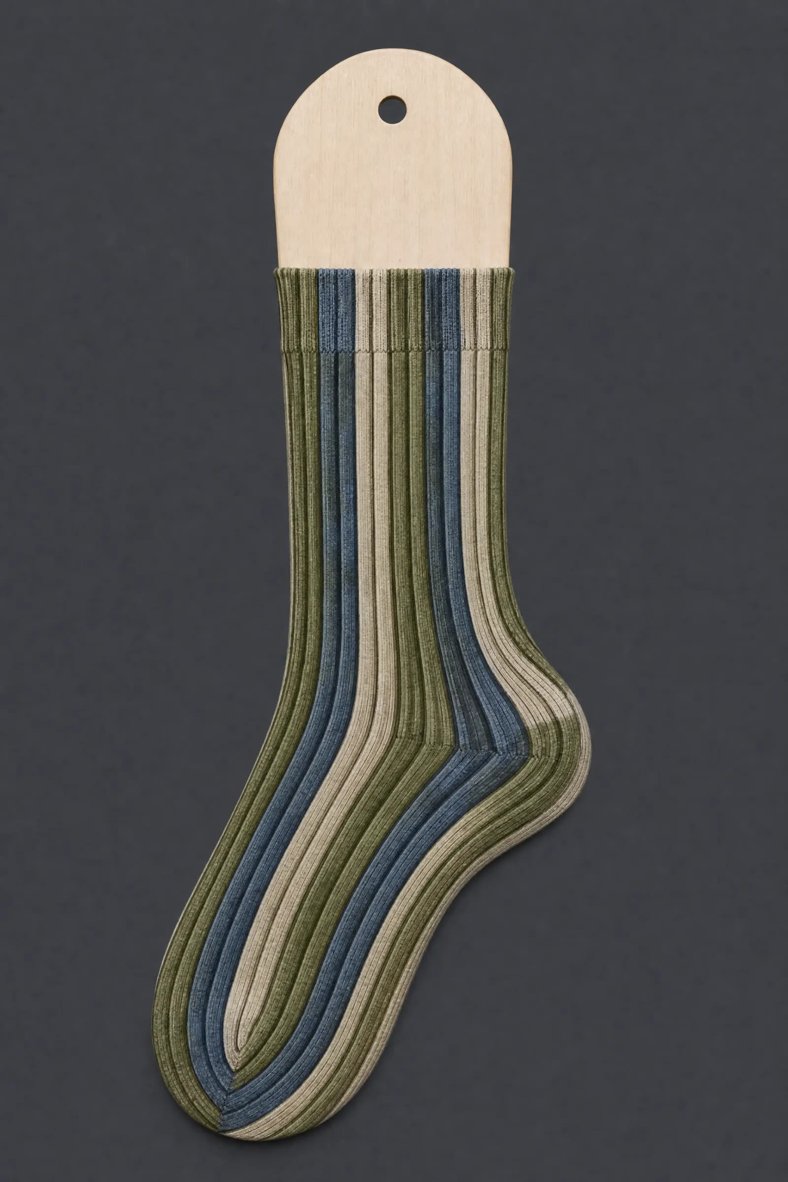 The Faux Corduroy pattern on a sock stretched over a sock form, showing how the drawing curves and compresses